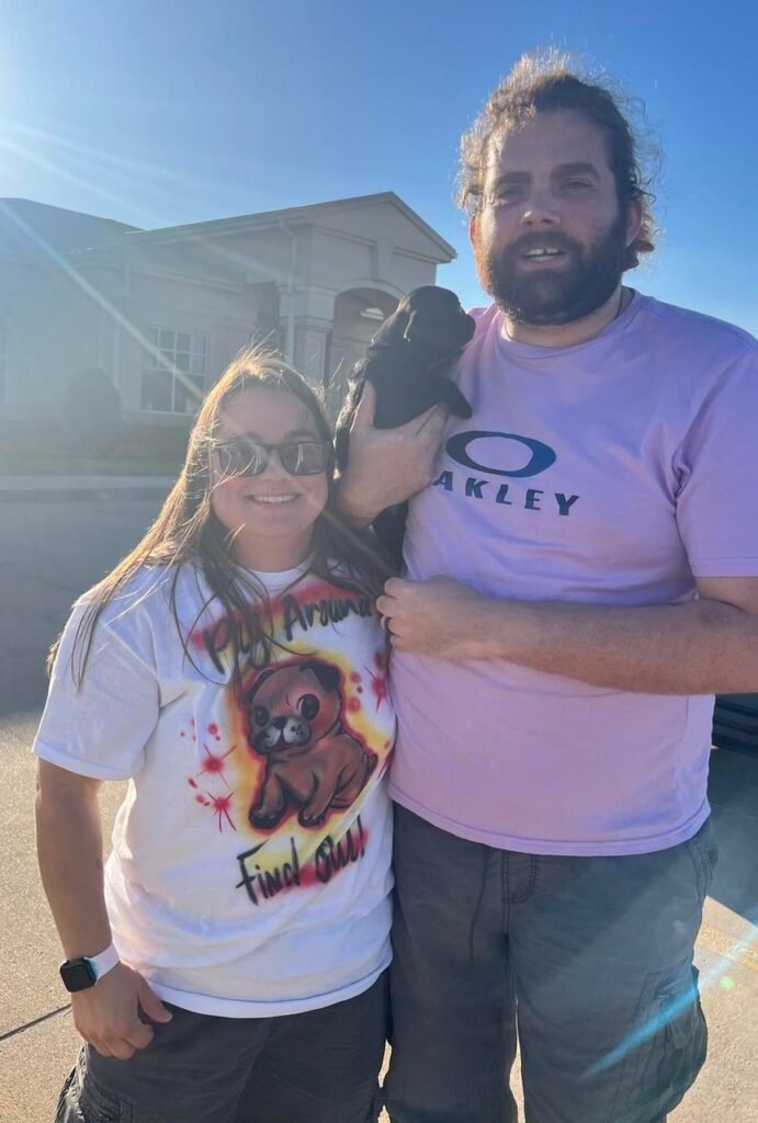 The Davis Family at home with Bella, their pug from Pug Forever Homes